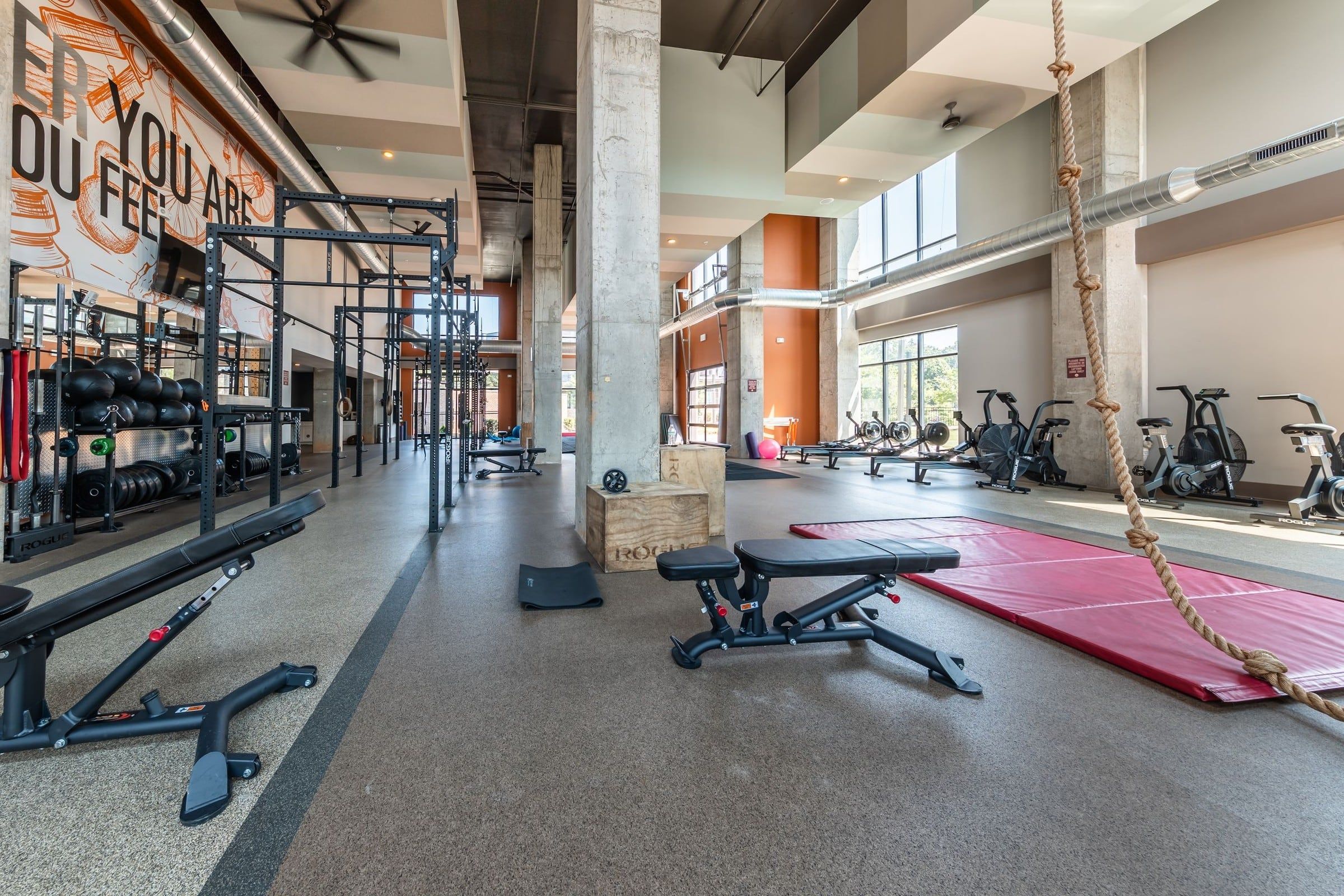 The Village at Commonwealth fitness center with climbing ropes, benches, squat racks, and more