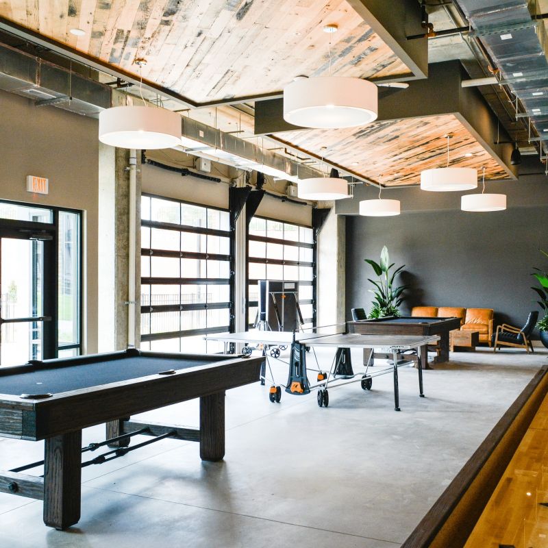 The Village at Commonwealth game lounge with billiards table, ping pong, shuffleboard, and foosball
